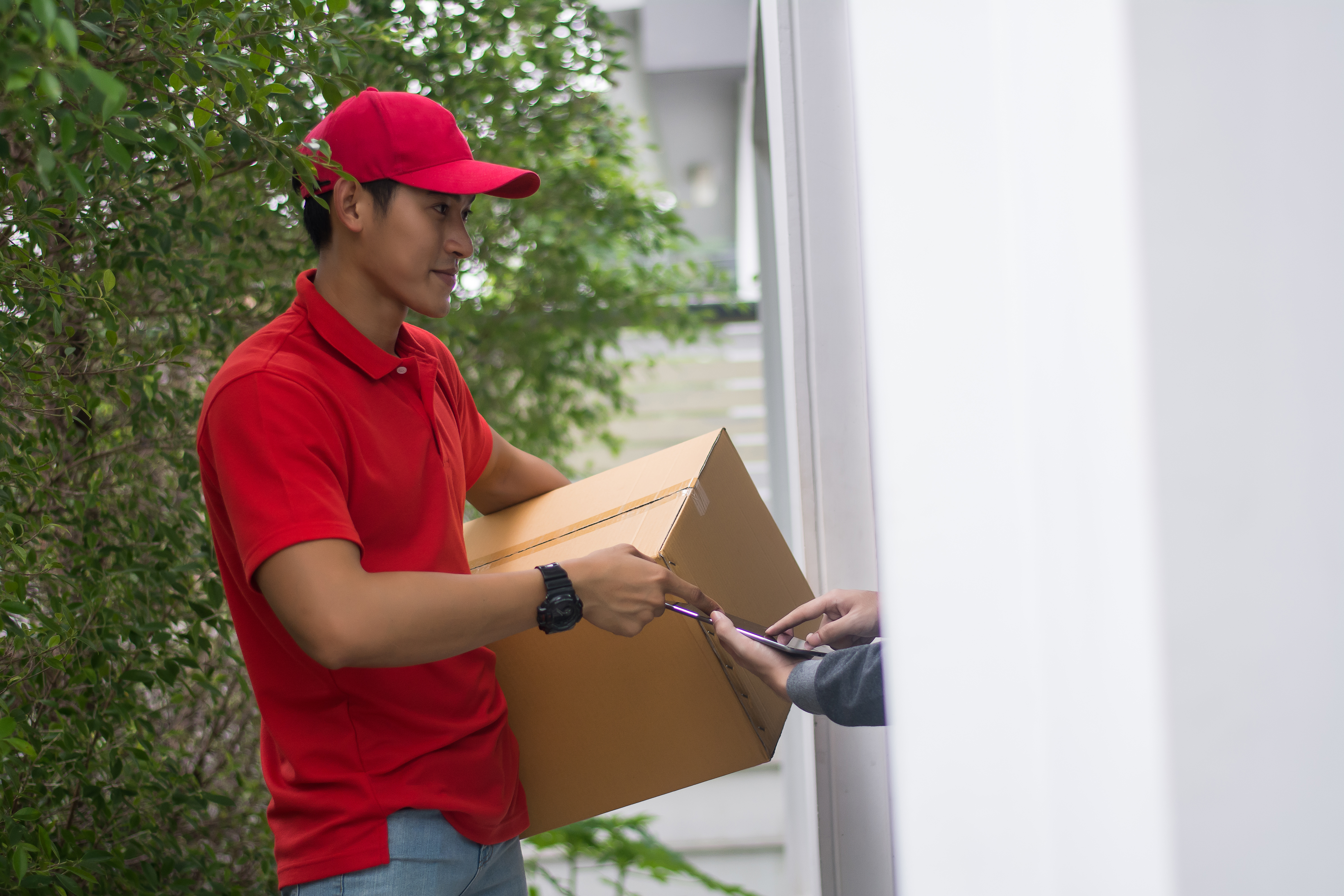 Young man Delivering Package to customer at home. Delivery